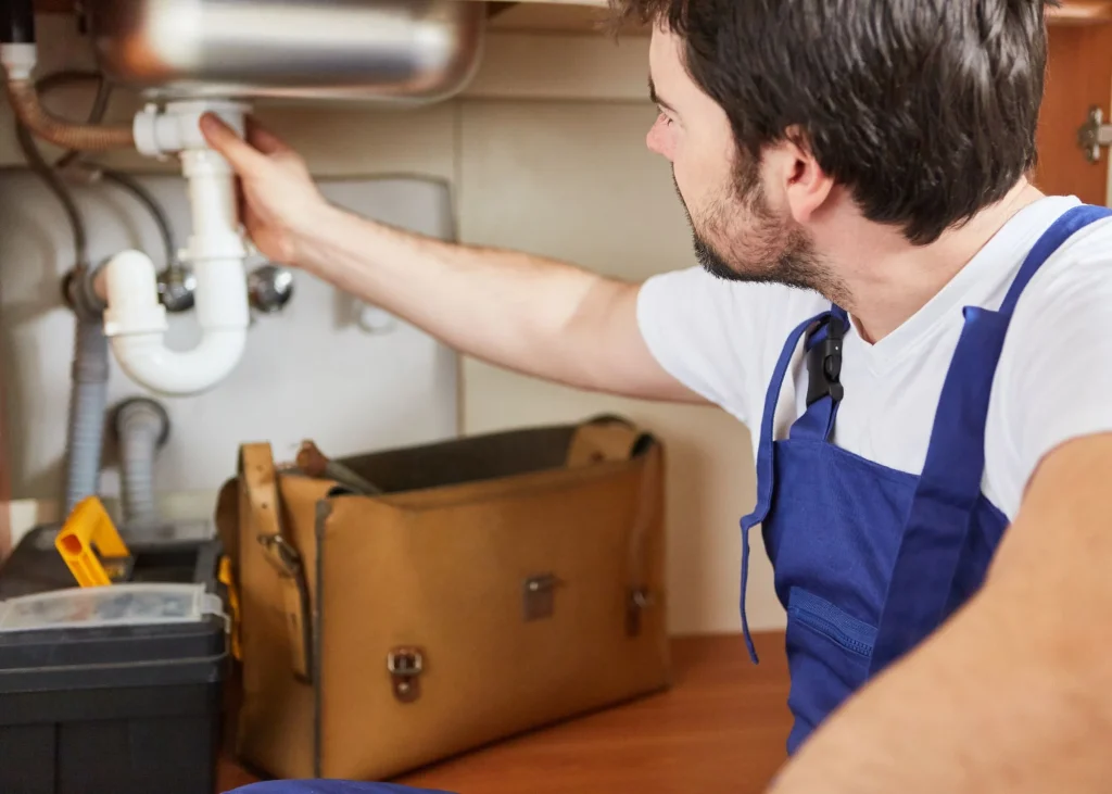 Jackson Mechanical technician fixing kitchen pipe